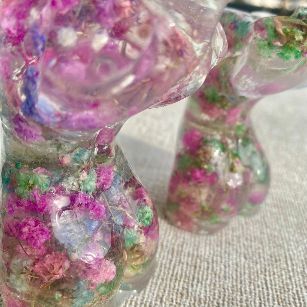 Decorative resin statues with floral embedded inside on a textured surface